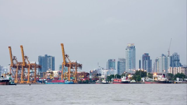 cargo shipping with city downtown at day to night on Chao Phraya river, Bangkok Thailand