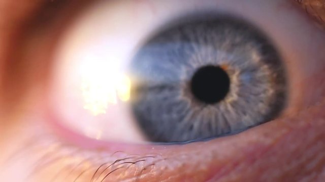 Extreme macro opening of a blue eye of young man in slow motion. 1920x1080
