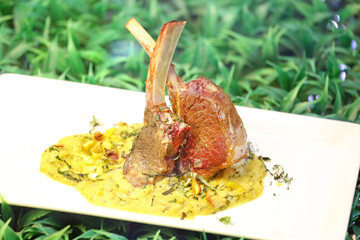 grilled pork chop with sweet sauce in white plate.