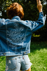 Girl enjoying the time in her garden in a denim jacket, hippie soul