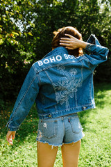 Girl enjoying the time in her garden in a denim jacket, hippie soul