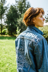 Girl enjoying the time in her garden in a denim jacket, hippie soul