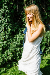 Blonde hair beautiful girl on the flower field