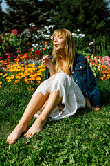Blonde hair beautiful girl on the flower field