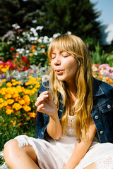 Blonde hair beautiful girl on the flower field