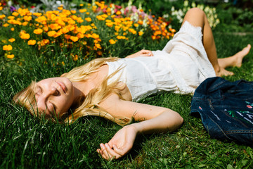 Blonde hair beautiful girl on the flower field