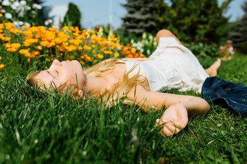Blonde hair beautiful girl on the flower field