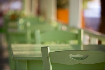 Tables and chairs in a street restaurant in Kamari on Santorini