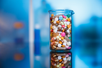 Tablets and capsules in a glass