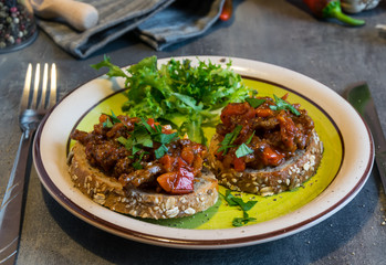 Beef meat mixture with tomatoes and pepper on fried bread, herbaceous. Great dinner