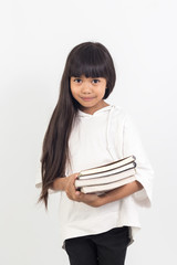 Portrait of asian little girl holding a book on white background