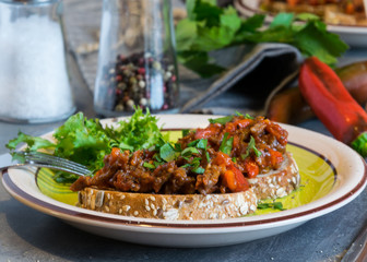 Beef meat mixture with tomatoes and pepper on fried bread, herbaceous. Great dinner