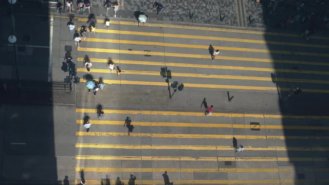 Aerial top view of people on crosswalk. 4K resolution