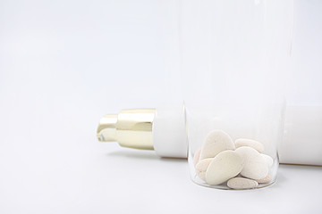 cosmetics with dispenser on white background