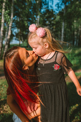 Young mother and daughter together having joyful moment of being together