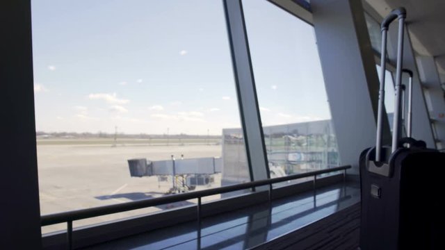 View through terminal window, gate and empty runway at airport, transportation