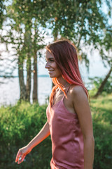 Portrait of stylish pink hair girl in the forest