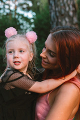 Young mother and daughter together having joyful moment of being together