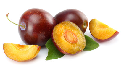 fresh plum fruit with cut plum slices isolated on white background