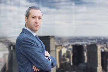 Fototapeta premium Successful business man looking confident and smiling, inside office