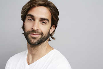 Fototapeta premium Bearded guy in grey studio, portrait