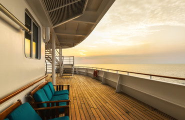 Luxury cruise ship deck at sunset.