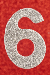 Number six silver color over a red background. Anniversary.