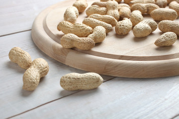 Peanuts in a shell lie on a board
