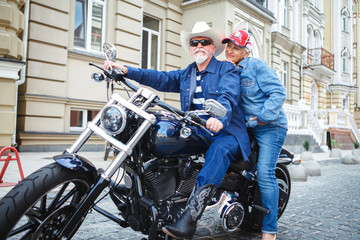 Mature man and woman on a motorcycle.