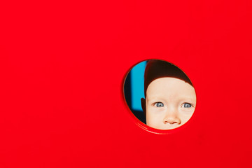 Portrait of a cute child boy with blue eyes, who is starring at the camera and smile.Outdoors healthy child activity, active lifestyle and having fun on family summer vacation with son at the playgrou