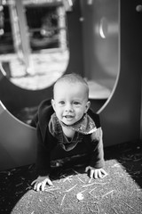 Portrait of a cute child boy with blue eyes, who is starring at the camera and smile.Outdoors healthy child activity, active lifestyle and having fun on family summer vacation with son at the playgrou