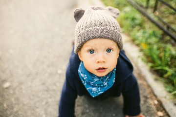 Portrait of a cute child boy with blue eyes, who is starring at the camera and smile.Outdoors healthy child activity, active lifestyle and having fun on family summer vacation with son at the playgrou