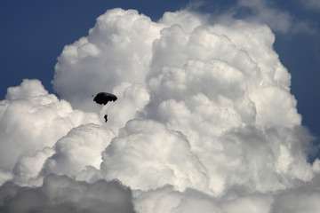 Fototapeta na wymiar Parashooter on the sky full of clouds