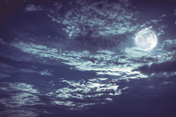 Naklejka na ściany i meble Beautiful night sky with dark cloudy. Some clouds overshadow the full moon.