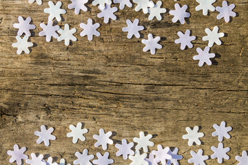Snowflakes on rustic wooden background