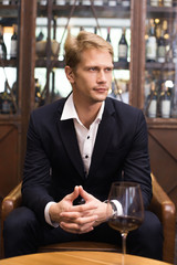 Portrait of a handsome Businessman sitting in restaurant, Man with Business Concept.