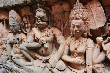 Fototapeta na wymiar Khmer art in Angkor complex. A close-up image of a beautiful vintage relief composition on the wall of a temple in Cambodia.