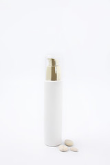 cosmetics with dispenser on white background