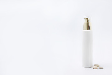 cosmetics with dispenser on white background