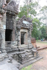 Fototapeta premium Ruins and walls of an ancient city in Angkor complex, near the ancient capital of Cambodia - Siem Reap