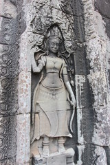 Khmer art in Angkor complex. A close-up image of a beautiful vintage relief composition on the wall of a temple in Cambodia.