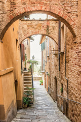 Beautiful narrow street in Montepulciano in Tuscany Italy. Montpulciano is famous for its wine.