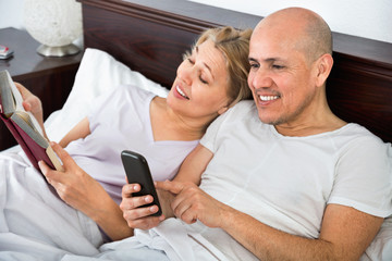 Positive happy mature couple together social networking