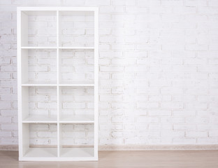 white wooden shelf over white wall
