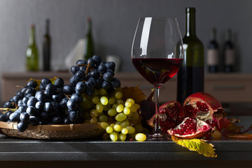 Blue and white grapes with glass of wine