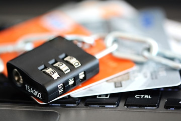 Online payments security with credit cards and padlock on notebook keyboard