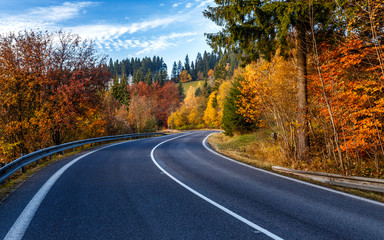 Turn on the road through the forest in autumn country - obrazy, fototapety, plakaty
