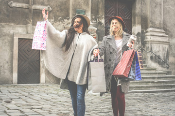 Fototapeta na wymiar Two best friends walking on the street . Young female best friends doing shopping on the streets.