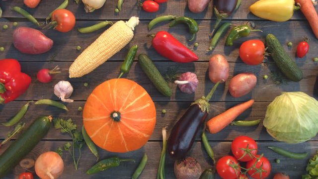 Vegetable mix on the table.
Top view. Close up. The smooth glide of the camera ( from right to left ) along the old village table with a variety of vegetables.