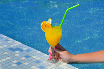 Real female beauty drinking cocktail near swimming pool